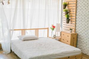 A white bed with a white sheet photo