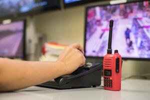 A person is using a red walkie talkie to talk to someone photo