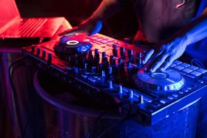 Dj mixing music on a dj mixer photo