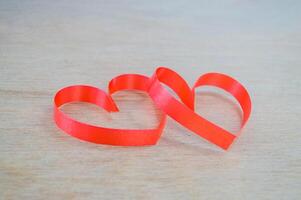 Two red hearts on a wooden surface photo