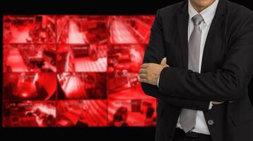 A man in a suit and tie standing in front of a red screen photo