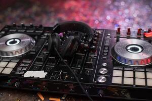 A dj mixer with headphones and a microphone photo