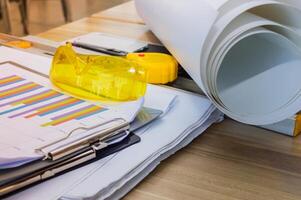 A desk with papers, a ruler, and a clipboard photo