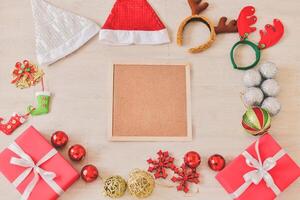 Christmas decorations on wooden table with blank board photo