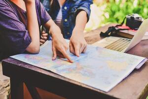 Two people looking at a map on a table photo
