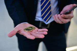A man holding a phone and a coin photo