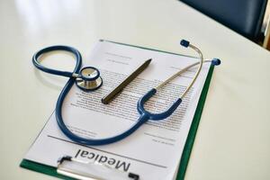 A stethoscope and a medical document on a desk photo