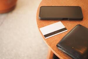 Items on a wooden table in a cozy cafe setting photo