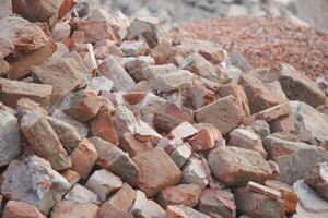 Pile of bricks and rubble at a construction site in daylight photo