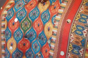 Vibrant fabric with intricate patterns and embellishments photo