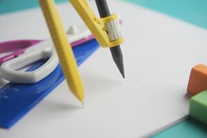 Tools are arranged for drawing and measuring on paper photo