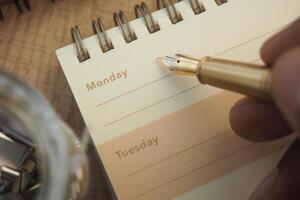 Writing plans for the week in a notebook photo