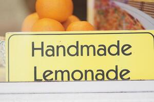 Refreshing handmade lemonade stand by vibrant oranges photo