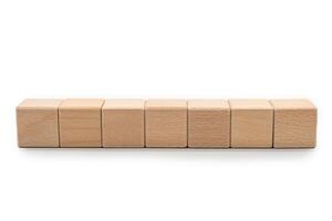 Seven Blank Wooden Blocks for Custom Text or Icons. Wood blocks arranged horizontally isolate on white background with clipping path. ideal for adding custom text, numbers or symbols. photo