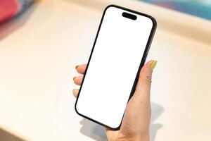 White Screen Smartphone Mockup in Woman Hand. Ideal for mockups, app demonstrations, or showing digital content. Woman Shopping. photo