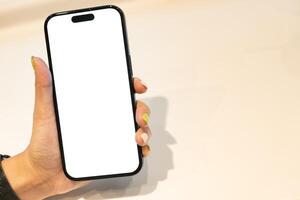 White Screen Smartphone Mockup in Woman Hand. Ideal for mockups, app demonstrations, or showing digital content. Woman Shopping. copy space. photo