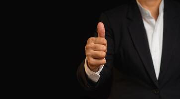 Close-up of a businessman gives the client satisfaction thumbs up for the best excellent services. photo