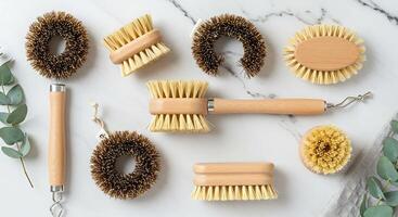 flat lay of eco-friendly cleaning brushes made from natural wood and plant based bristles photo