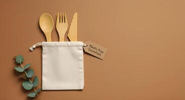 wooden kitchen utensils, fork, knife, and spoon in a linen pouch. photo