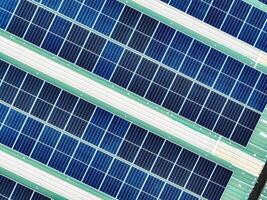 Aerial view of a warehouse rooftop featuring solar panels generating green electricity. The shift to renewable energy, clean power solutions, and environmental sustainability for modern industries. photo