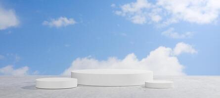White cylindrical pedestals outdoors with blue sky and clouds for product display photo