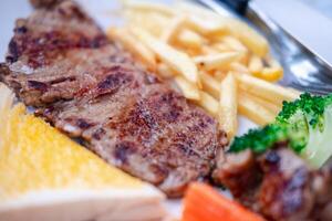 Grilled beefsteak with french fries and mixed vegetables photo