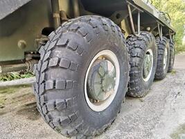 Close-up of military armored vehicle wheel and tire texture photo