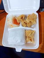 Fried Chicken Meal in Styrofoam Container, Takeout Food, Overhead View. photo