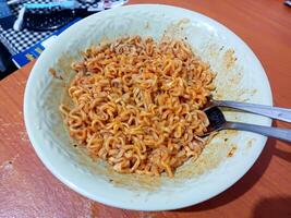 Spicy Instant Noodles in a Bowl, Ready to Eat, Close-Up Shot, Food Photography. photo