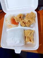 Fried Chicken Meal in Styrofoam Container, Takeout Food, Close-up, Overhead View. photo