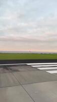 A sequence showing an airplane accelerating down the runway at Auckland Airport during a cloudy day video
