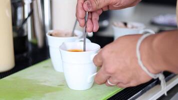 Stirring and adding cream to coffee video