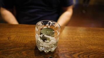 Man moves glass of beer on table video