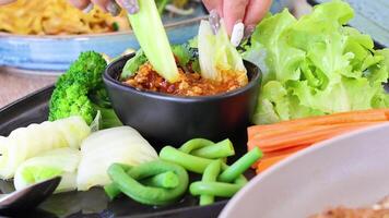 Demonstrating chili dip preparation with vegetables video