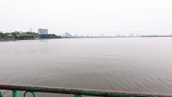 Peaceful lakeside path with trees and benches video