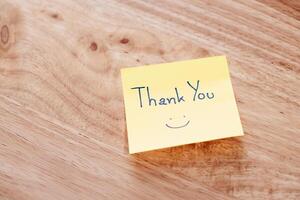 Gratitude note wooden table home office cozy environment close-up view thankfulness concept photo