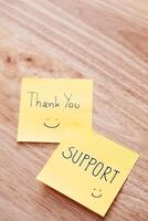 Thank you support notes wooden table positive message cozy home environment close-up view photo