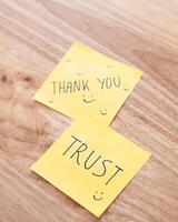 Trust and gratitude sticky notes office desk motivational content bright environment close-up view photo