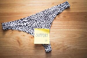 Support note underwear creative display home still life close-up confidence boost photo
