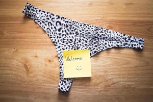 Welcome note leopard print underwear home setting product cozy environment close-up perspective photo