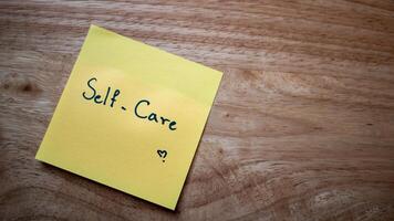 Self-care practices for a balanced life home office sticky note relaxing close-up mindfulness photo