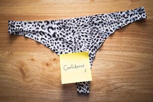 Empowering note underwear confidence unique design home setting close-up perspective photo