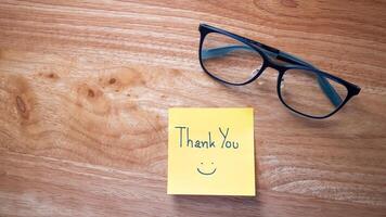 Gratitude gesture thank you note table with glasses home office still life warm atmosphere photo