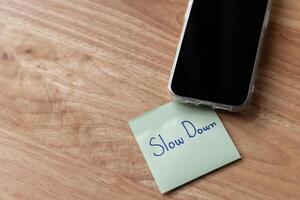 Mindful reminder to slow down phone desk with note minimalist setting calm environment photo