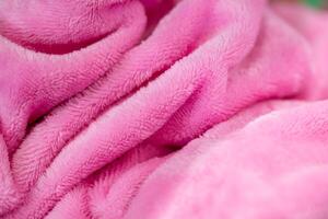Cozy pink blanket indoor setting textile close-up soft environment texture focus photo