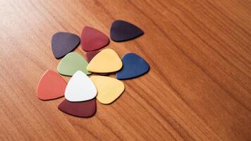 Colorful guitar picks arranged wooden surface artistic still life creative space close-up view photo