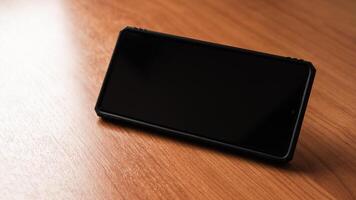 Smartphone wooden surface technology showcase minimalistic environment close-up view photo