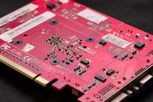 Exploring the intricacies of a red circuit board technology workshop detailed close-up industrial environment photo