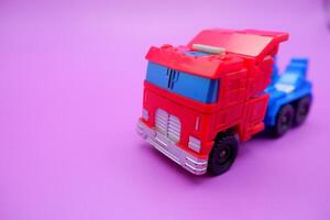 Miniature Action Truck on Vibrant Pink Surface photo