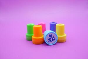 Well Done Stamp and School Reward Tools on Purple Background photo